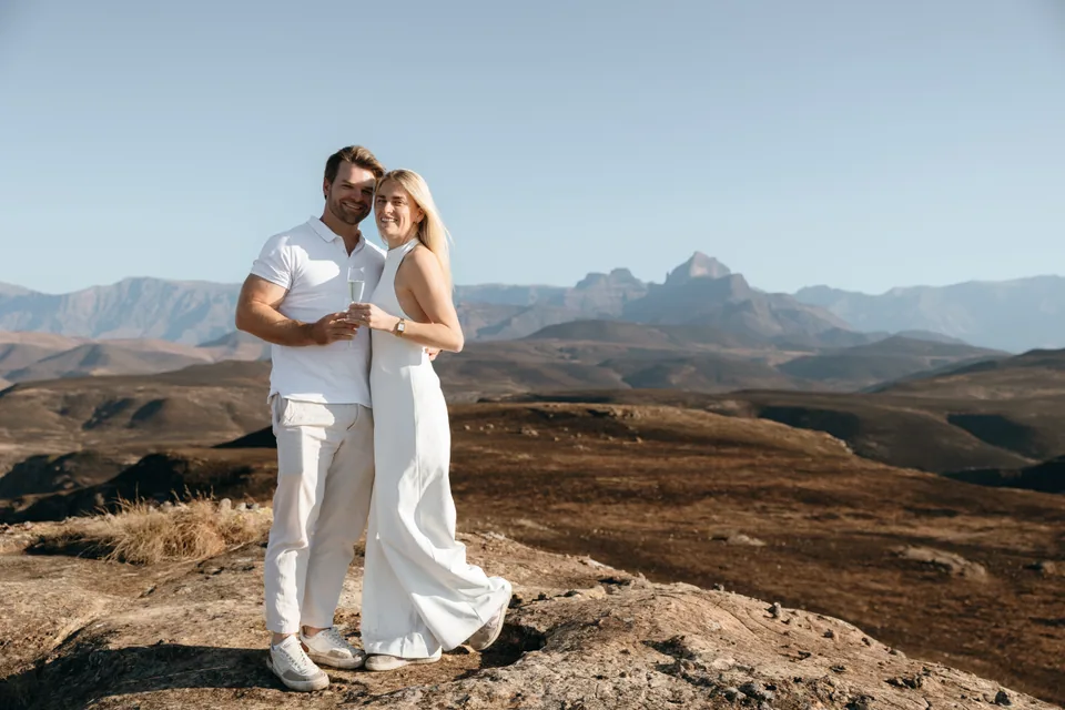 Christy and Joshua holding each other with the Drakensberg peaks behind them