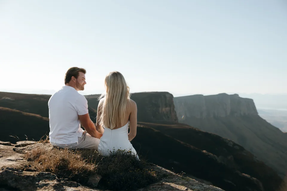 Christy and Joshua sitting on the cliff edge looking at the view