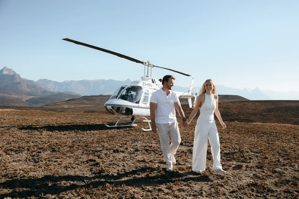 Christy and Joshua walking hand in hand away from the helicopter