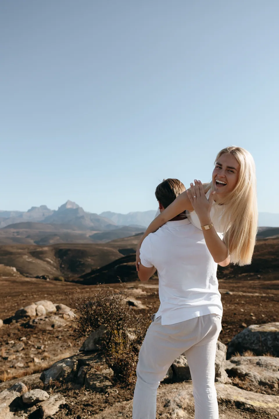 Christy laughing as Joshua lifts her