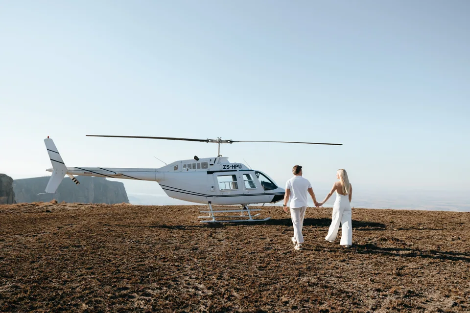 Walking towards the helicopter, hand in hand