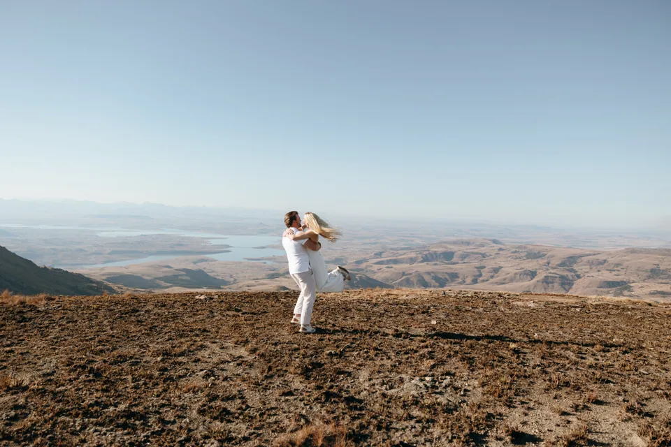 Joshua lifting Christy at the edge of the escarpment