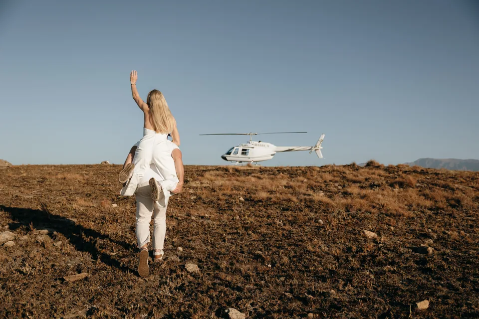 Christy running towards the helicopter, arm raised