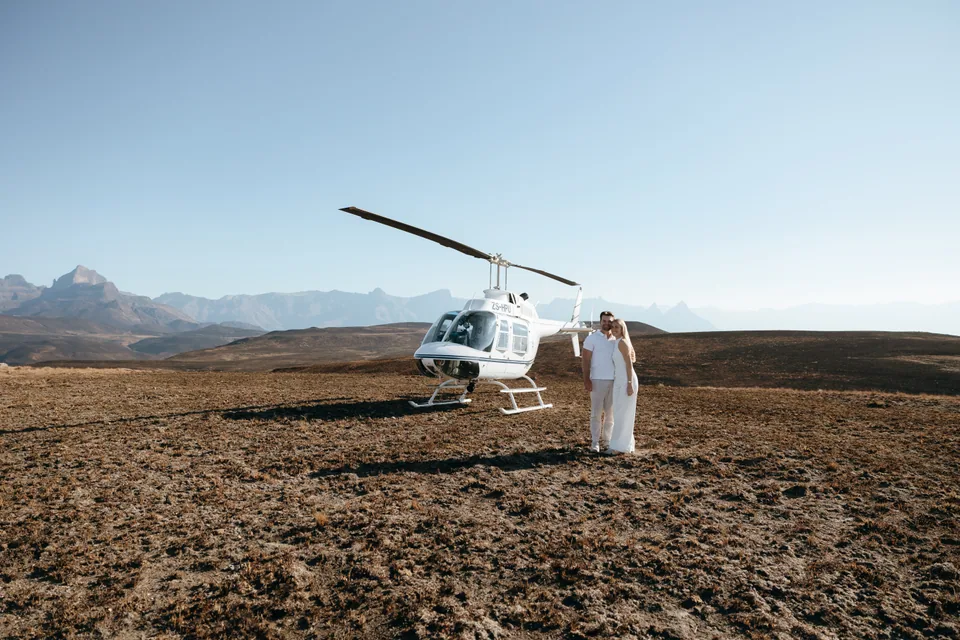 The helicopter waiting on the plateau, Christy walking towards it