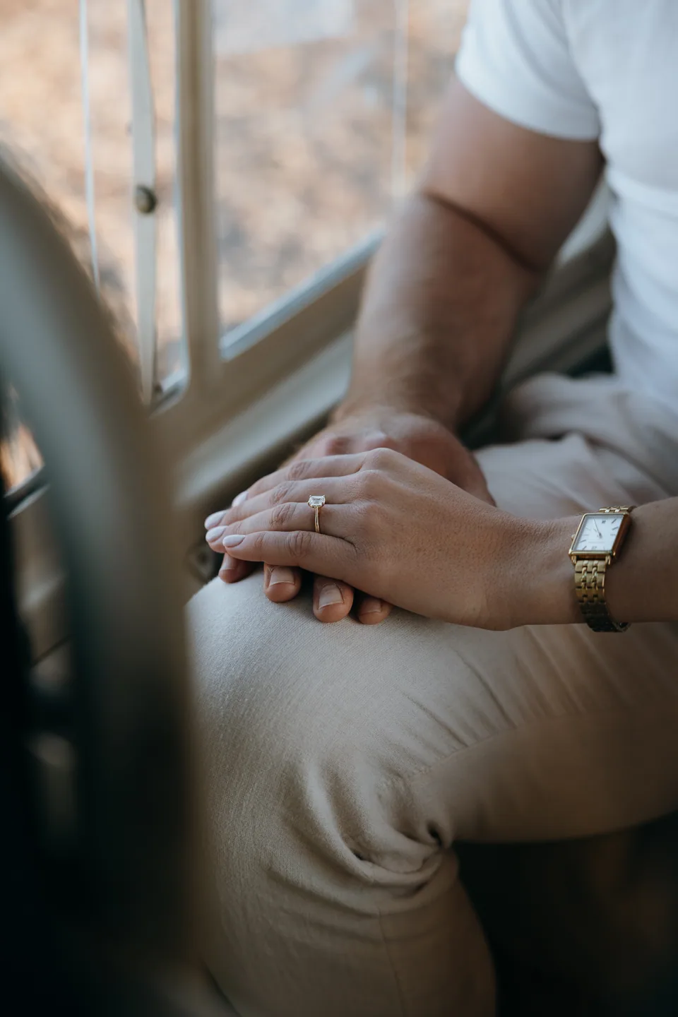 Hands resting together in the back of the helicopter