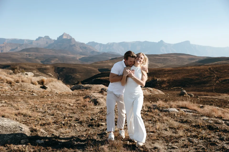 Christy and Joshua embracing, the Drakensberg behind them